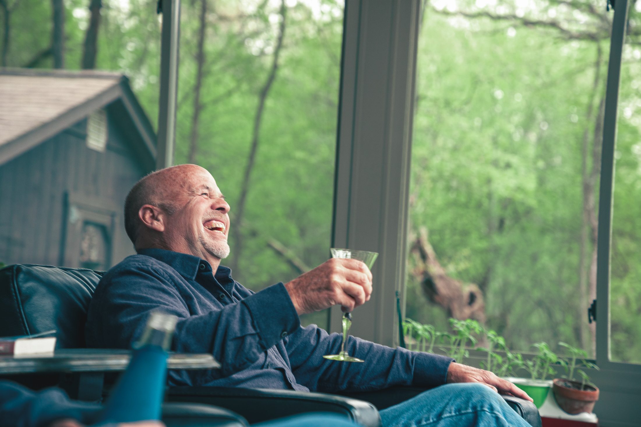 A South Jersey homeowner relaxing in a finished sunroom in warm afternoon light